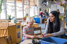 Child development student and child playing