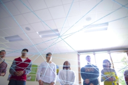 string lines in front of students standing in a circle