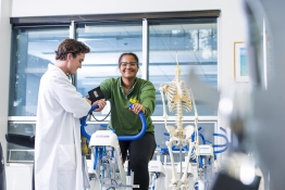 Kinesiology student studying someone on a bike